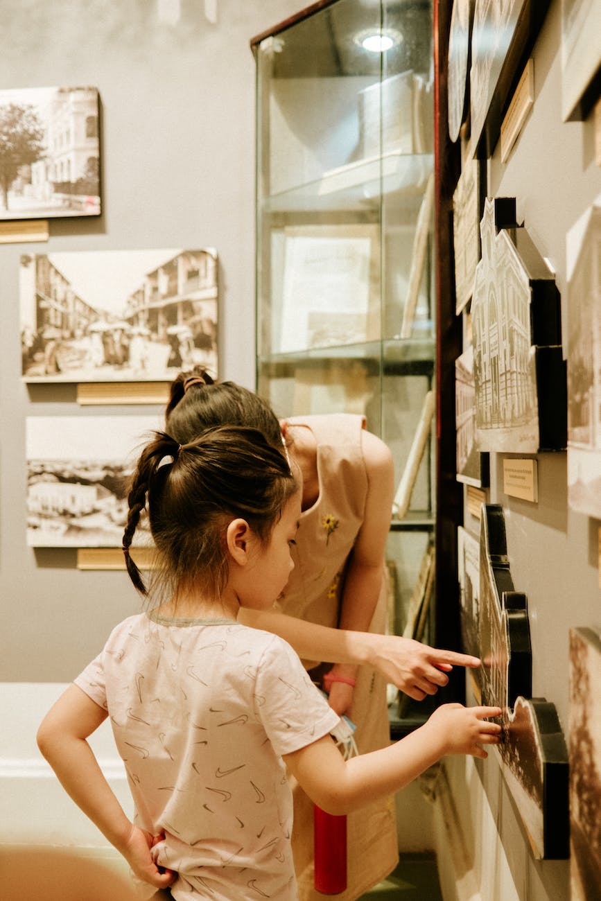 woman showing an exhibit to her daughter