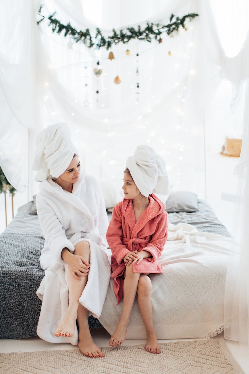 mother and daughter in dressing gowns and with their hair wrapped in a towel